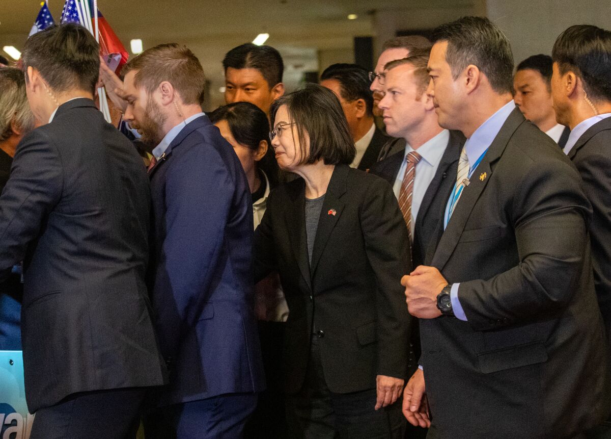 Security personnel surround Taiwan President Tsai Ing-wen as she arrives at her hotel in LA