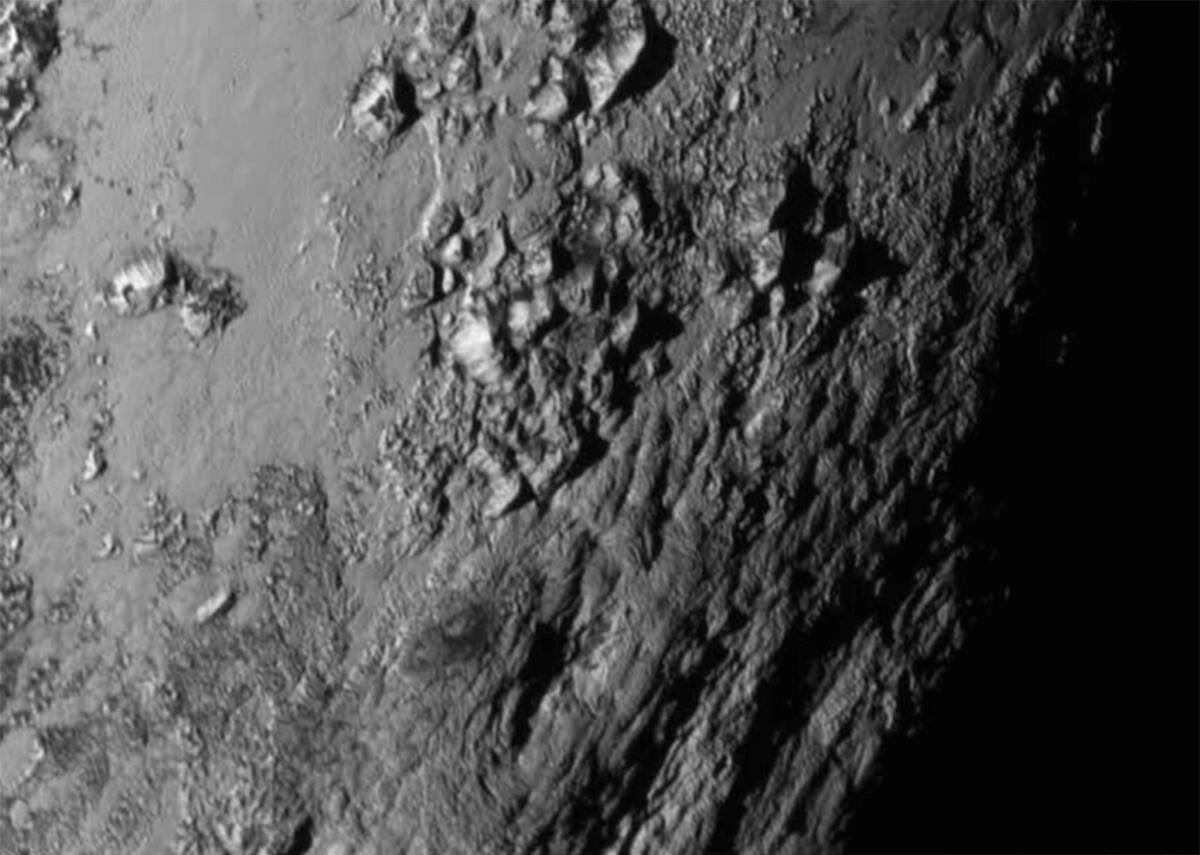 New close-up images of a region near Pluto's equator reveal a giant surprise -- a range of youthful mountains rising as high as 11,000 feet (3,500 meters) above the surface of the icy body.