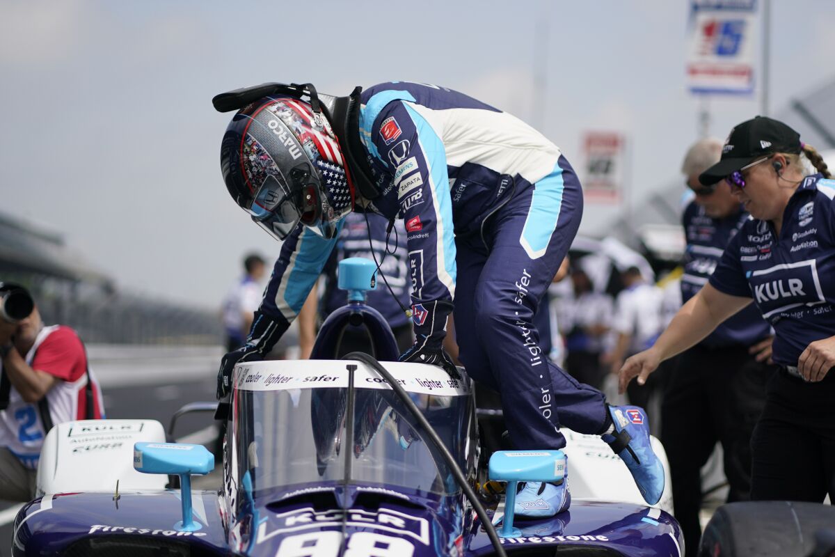 Marco Andretti climbs into his car during practice for the Indianapolis 500 auto race at Indianapolis Motor Speedway, Thursday, May 19, 2022, in Indianapolis. (AP Photo/Darron Cummings)