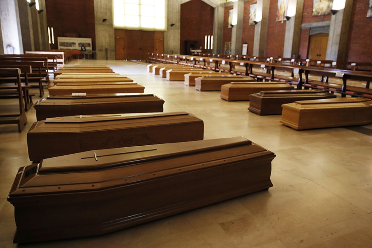 Coffins inside a church near Bergamo, Italy.