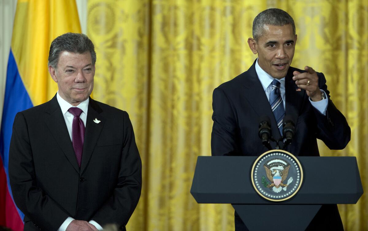 President Obama, with Colombian President Juan Manuel Santos, speaks at a reception for Plan Colombia, the U.S. aid program for Colombia, in the White House on Thursday.