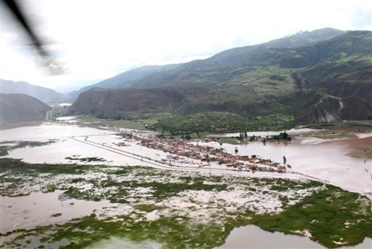 In this photo released by the Peruvian Government Press office a flooded area is seen in this aerial view due to the overflow of the Urubamba river in Cuzco, Peru, Tuesday, Jan. 26, 2010. Heavy rains and mudslides in Peru blocked the train route to the ancient Inca citadel of Machu Picchu, keeping nearly 2,000 tourists stranded.(AP Photo/Government Press office)