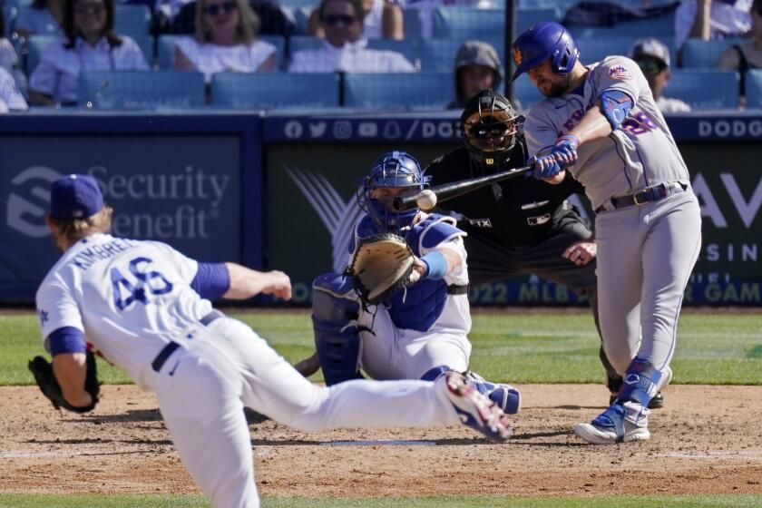 New York Mets' J.D. Davis, right, hits an RBI double as Los Angeles Dodgers relief pitcher Craig Kimbrel.