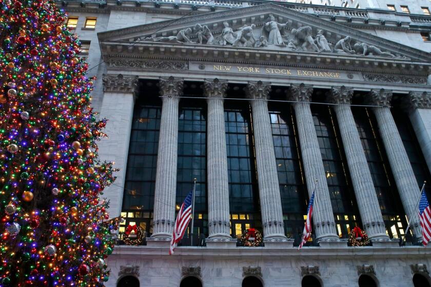 Christmas decorations adorn the facade of the New York Stock Exchange, Monday, Dec. 4, 2017, in New York. Designed by George B. Post, the neo-classic building opened on April 22, 1903, after an earlier, Victorian era building was demolished. A marble sculpture by John Quincy Adams Ward called "Integrity Protecting the Works of Man" adorns the pediment, supported above six Corinthian capitals. (AP Photo/Kathy Willens)