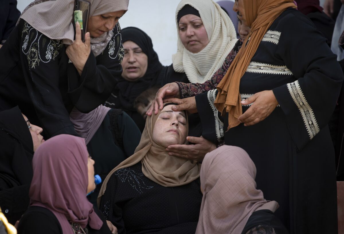 Palestinian women mourn during the funeral of a Palestinian security officer, Tayseer Issa, in the West Bank city of Jenin, Thursday, June 10, 2021. Israeli troops shot and killed three Palestinians, including two security officers, in a shootout that erupted in the West Bank town of Jenin during what appeared to be an Israeli arrest raid overnight, Palestinian officials said Thursday. (AP Photo/Majdi Mohammed)