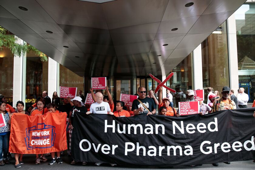 Activists rally in New York during a protest against the price of drugs.