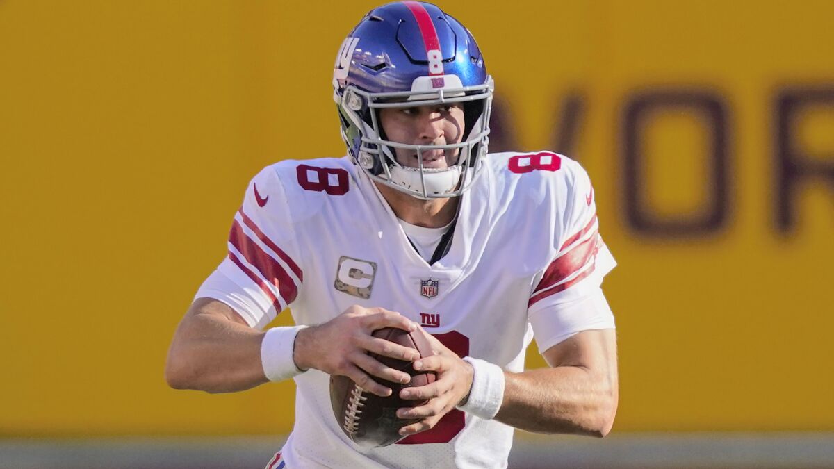 New York Giants quarterback Daniel Jones scrambles with the ball in the first half of an NFL football game against the Washington Football Team, Nov. 8, 2020, in Landover, Md. Daniel Jones is looking to stay undefeated in his career against Washington when he leads the New York Giants into the NFC East matchup on Thursday, Sept. 16, 2021. The sixth pick in 2019 is 4-0 against Washington and 4-19 against the rest of the NFL. (AP Photo/Al Drago, file)