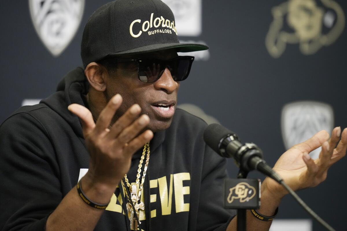 Colorado coach Deion Sanders responds to questions during a news conference on Aug. 4.