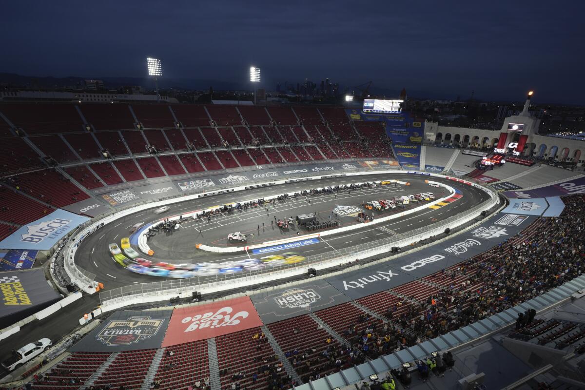 Cars race around the Coliseum during the NASCAR Busch Light Clash at the Coliseum on Saturday night.