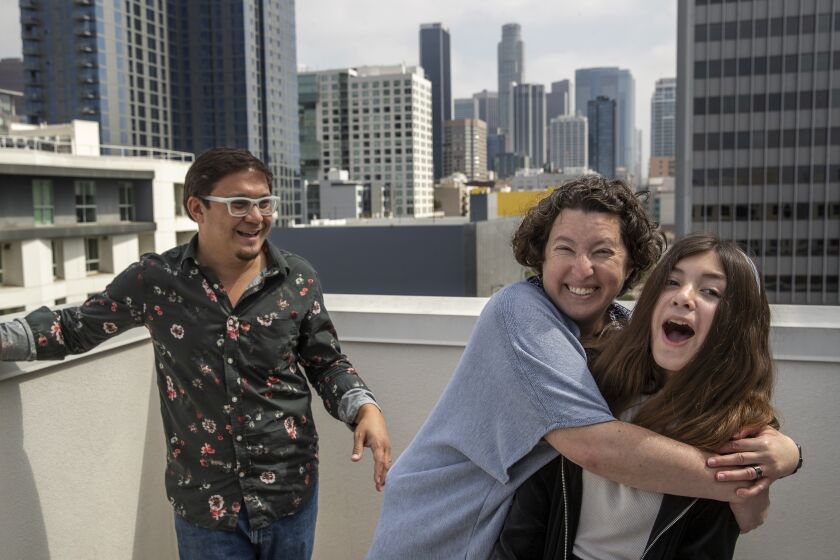 LOS ANGELES, CA - MAY 14, 2021: Alex Brideau, 44, his wife Ginny, 44, and daughter Iolani, 12, are photographed on the rooftop of their apartment building in downtown Los Angeles. As California expands vaccine eligibility to adolescents, parents weigh the risk and reward. Alex and Ginny Brideau have secured an appointment for their daughter to be vaccinated next week. (Mel Melcon / Los Angeles Times)