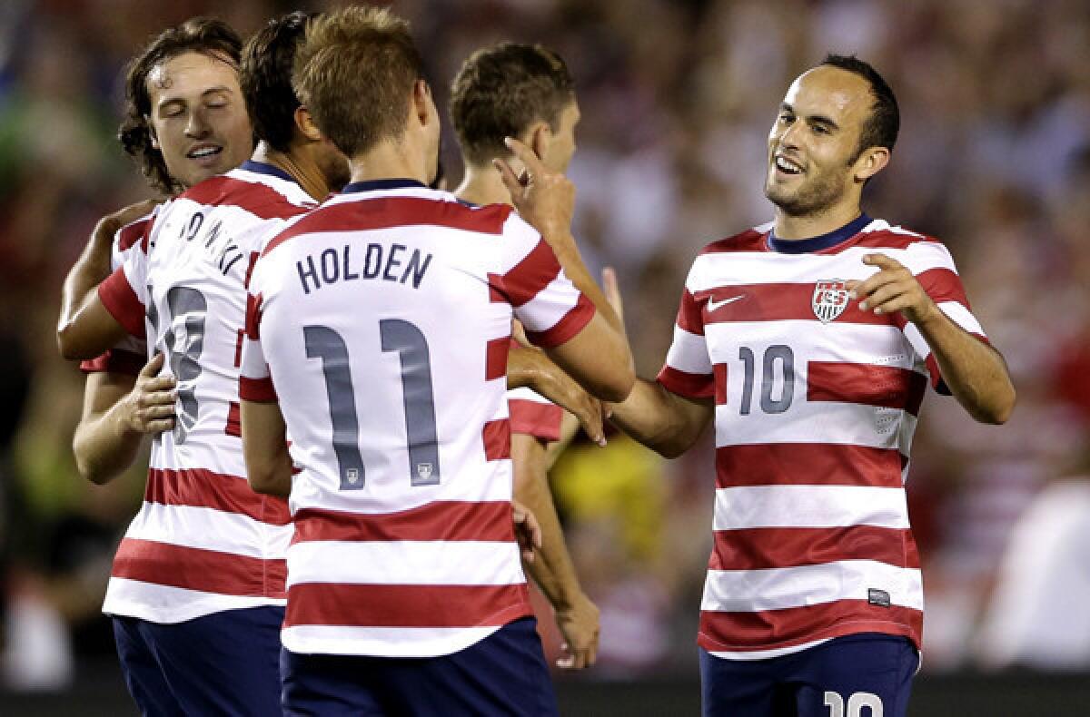 Landon Donovan (10) and Stuart Holden (11) celebrate after combining on the U.S. team's fourth goal in a 6-0 victory over Guatemala on Friday.
