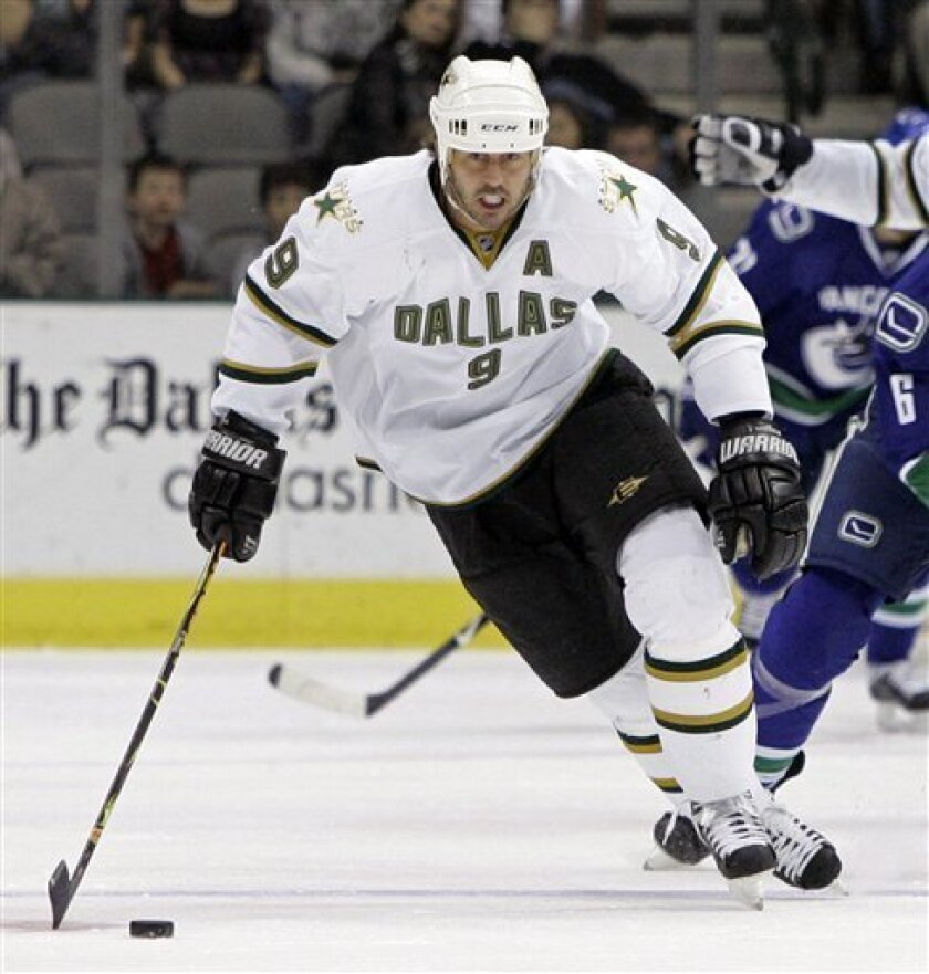 FILE - In this Feb. 13, 2009, file photo, Dallas Stars center Mike Modano controls the puck during an NHL game against the Vancouver Canucks, in Dallas. Stars general manager Joe Nieuwendyk said Tuesday, June 29, 2010, that Modano, the face of the franchise that proved hockey could thrive in the South will not be offered a contract by the Stars when free agency opens on Thursday, July 1. (AP Photo/Tony Gutierrez, File)