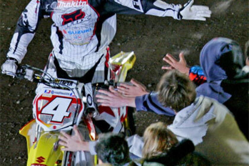 Ricky Carmichael greets fans at Angel Stadium. The 27-year-old will be giving NASCAR a try, and James Stewart, who defeated Carmichael on Saturday, is an heir apparent in a sport whose racers fly faster, farther and higher than anyone thought possible just two years ago.