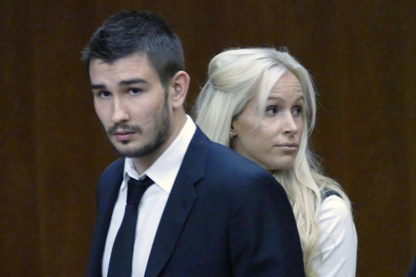 FILE - In this July 2, 2015, file photo, Los Angeles Kings' Slava Voynov enters Superior Court with his wife, Marta Varlamova, in Torrance, Calif. Voynov says he will return home to Russia, leaving the Kings in the wake of his legal troubles surrounding domestic violence charges. Voynov announced his intention to self-deport Wednesday, Sept. 16, 2015, in a statement through his agent, Rolland Hedges. (Brad Graverson/The Daily Breeze via AP) MAGS OUT; NO SALES; MANDATORY CREDIT