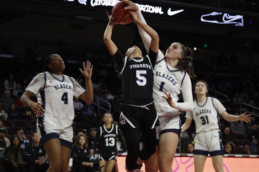 LOS ANGELES, CA - JANUARY 7, 2023: Sierra Canyon Emilia Krstevski (1) blocks the shot by La Jolla Country Day guard Sumayah Sugapong (5) as Sierra Canyon Mackenly Randolph (4) defends on the left during the Chosen-1's Invitational Basketball Showcase at Galen Center on January 7, 2023 in Los Angeles, California.(Gina Ferazzi / Los Angeles Times)