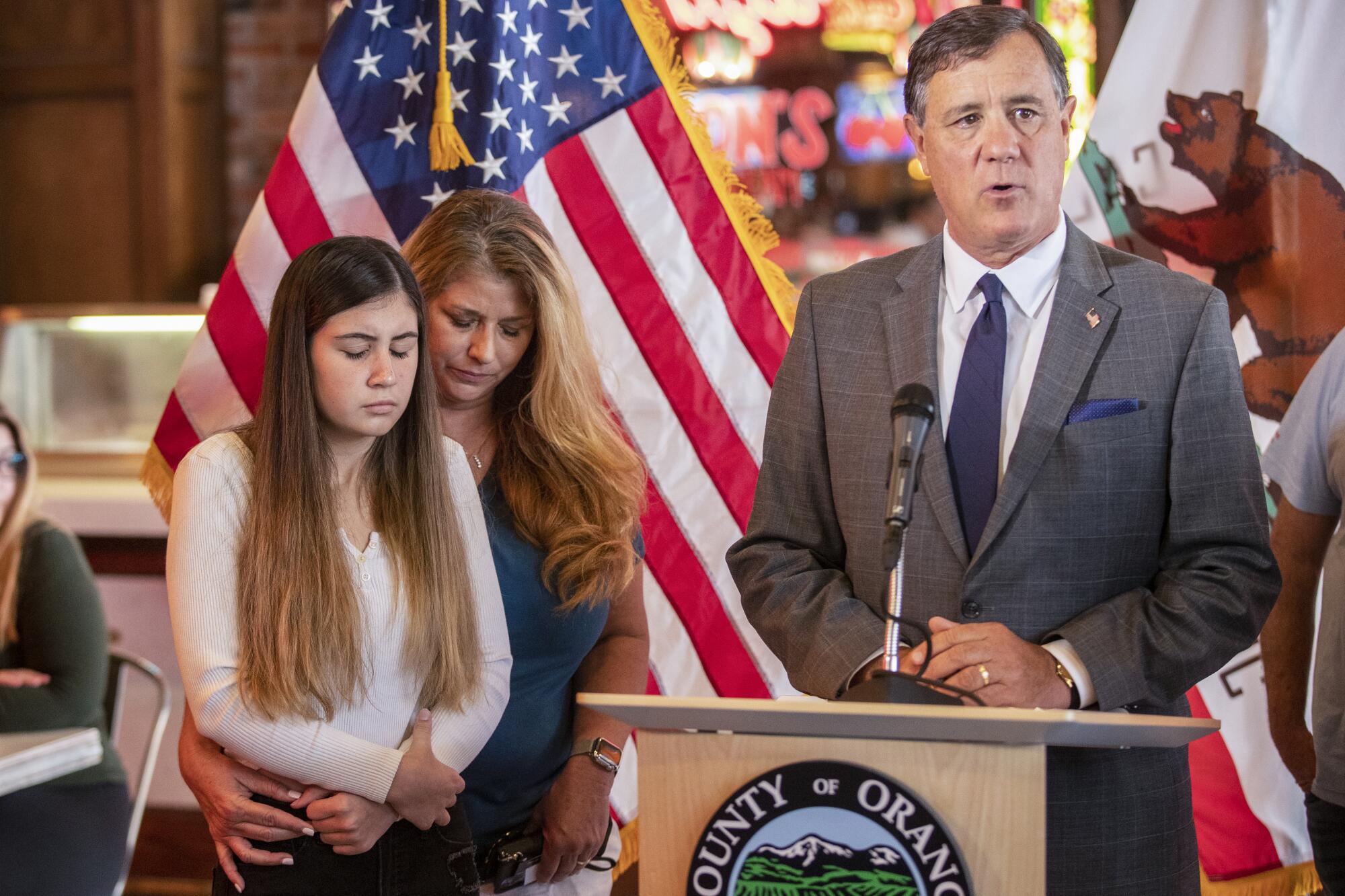 Alexis Cloonan, left, Aiden Leos' sister, and Carole Ybanez, a friend of Alexis' mother, listen to politician Don Wagner.