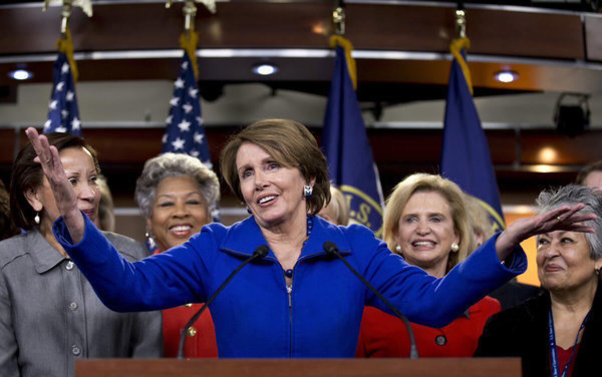 House Minority Leader Nancy Pelosi (D-Calif.), accompanied by female House Democrats, speaks at a news conference on Capitol Hill in Washington.