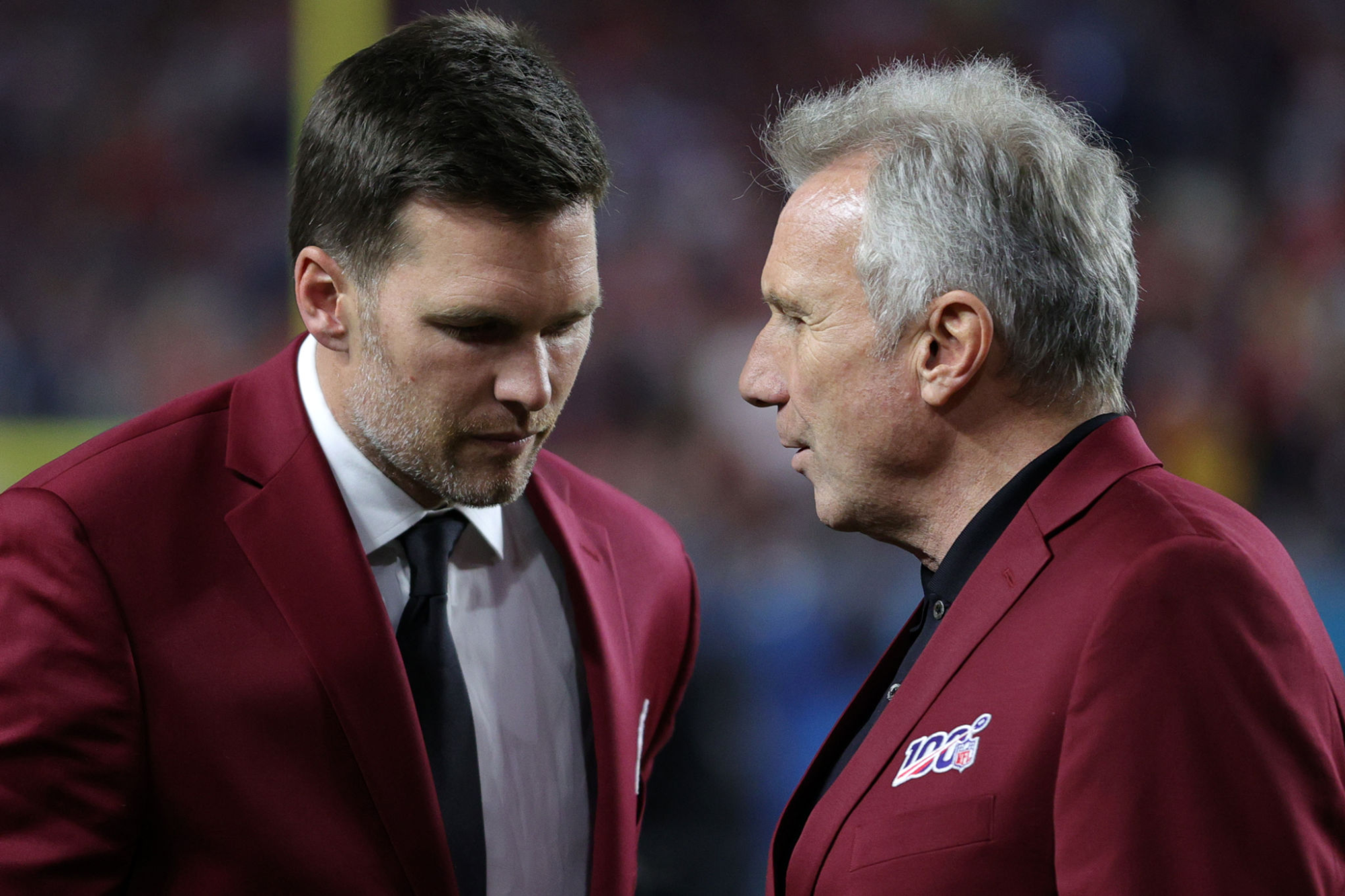 Tom Brady speaks with Hall of Fame quarterback Joe Montana.