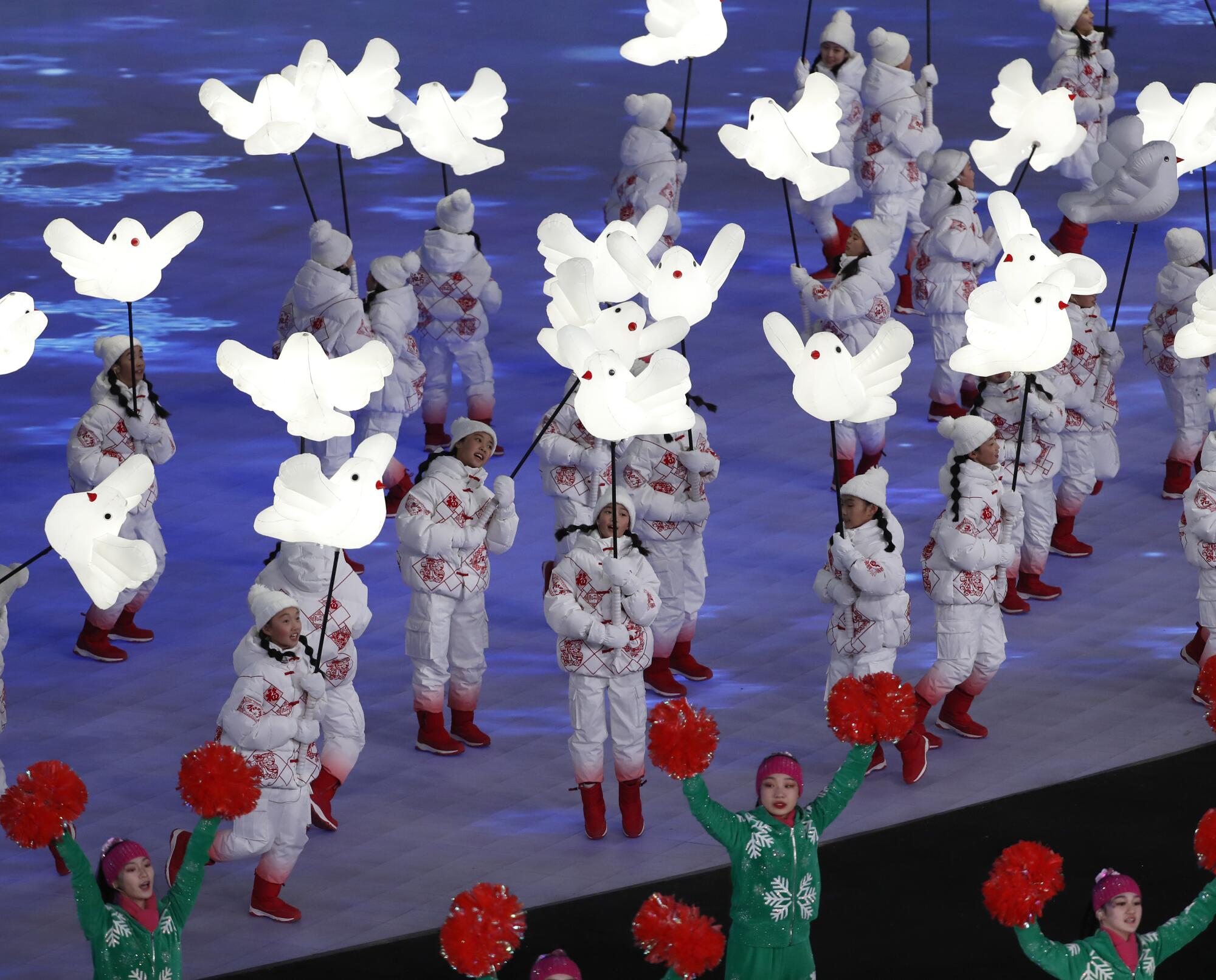 Children dance with lighted doves.