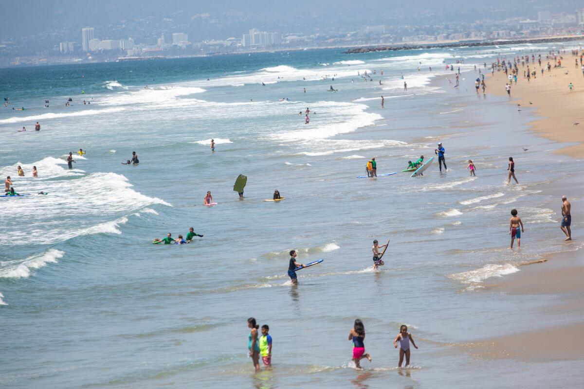 Scenes from Manhattan Beach on Thursday, the day before Los Angeles County beaches close for the July 4th holiday. 