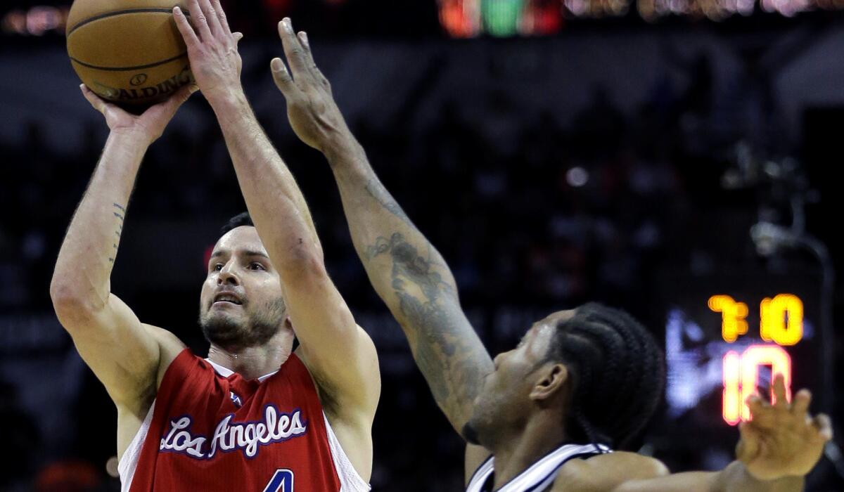 Clippers guard J.J. Redick has his shot challenged by Spurs forward Kawhi Leonard in Game 3 of their first-round playoff series in San Antonio on April 24.