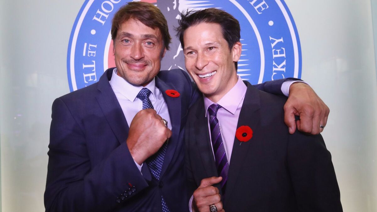 Teemu Selanne and Paul Kariya pose for photos during a media opportunity at the Hockey Hall of Fame and Museum.