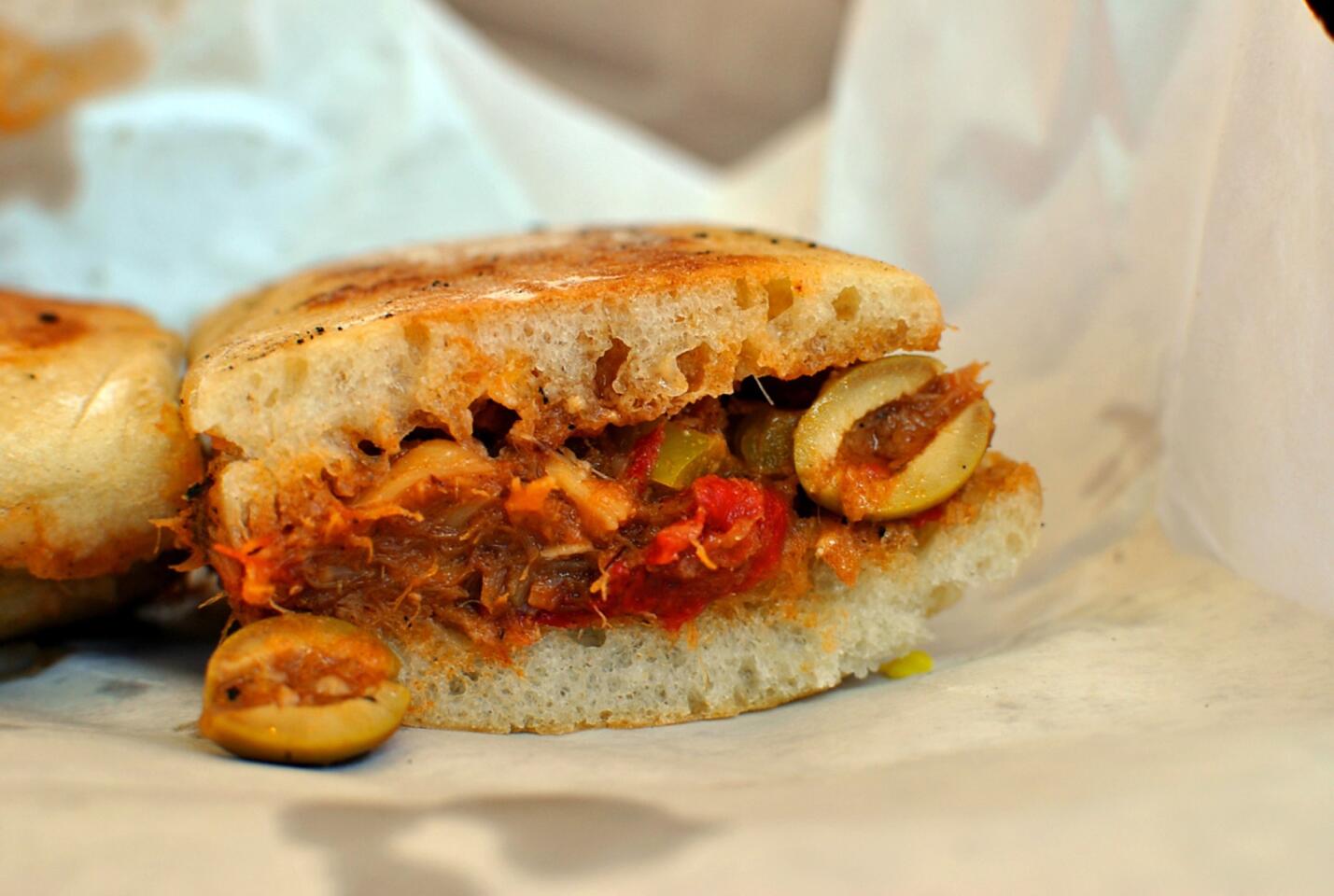 The torta de bacalao at Cook's Tortas in Monterey Park is stuffed with a Mexican-style salted cod guisado, seasoned with olives, red pepper and garlic. All of the restaurant's tortas are made with chewy, ciabatta-like handmade rolls baked fresh each morning.