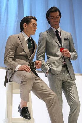 Bare ankles emerge from the otherwise classic look of suits in a tropical club tableau at the Valentino show.