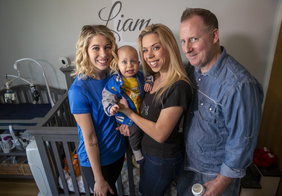 UCLA gymnast Mercedez Sanchez, left, stands next to her baby brother, Liam, her mother Rosemarie Sanchez and stepfather Chris Clark.