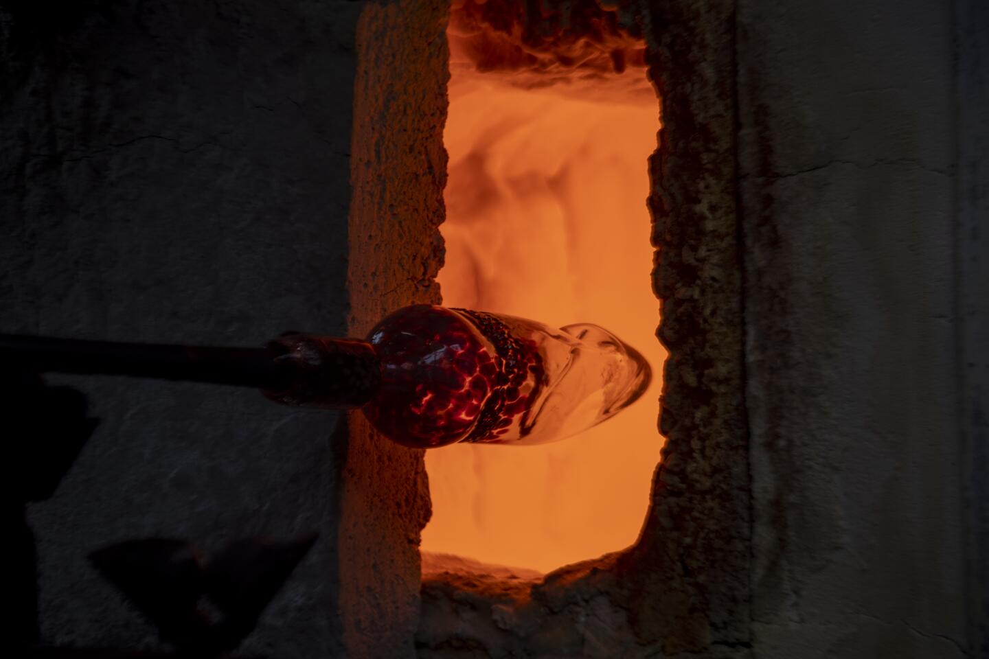 Molten glass glows during a demonstration at the Sawdust Festival, one of the many attractions for visitors to take in on a summer day.