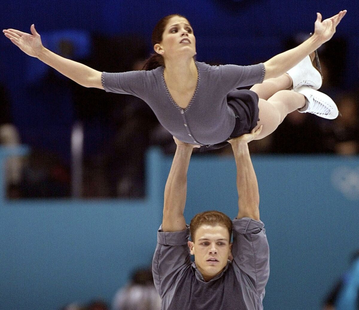 FILE - Canadian figure skaters Jamie Sale and David Pelletier compete in the pairs free program in the Winter Olympics at the Salt Lake Ice Center in Salt Lake City, Monday, Feb. 11, 2002. Tara Lipinski, the 1998 Olympic gold medalist and now an analyst for NBC, partnered with husband Todd Kapostasy on a four-part documentary series on Peacock, NBC's streaming outlet. It's called “MEDDLING” and looks deeply into the impact the judging misdeeds had on the two pairs teams involved: Canadians Jamie Sale and David Pelletier, Russians Elena Berezhnaya and Anton Sikharulidze.(AP Photo/Lionel Cironneau, File)