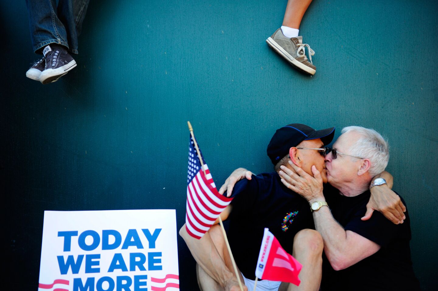 Carlos Jimenez, left, and Mike Dardenelle of the San Fernando Valley kiss during a gathering on San Vicente Boulevard celebrating the Supreme Court decision Wednesday affirming a lower court's ruling that declared Proposition 8, which banned gay marriage in California, unconstitutional. Jimenez and Dardenelle, who met online, have been dating for 15 years and plan to get married as soon as possible.