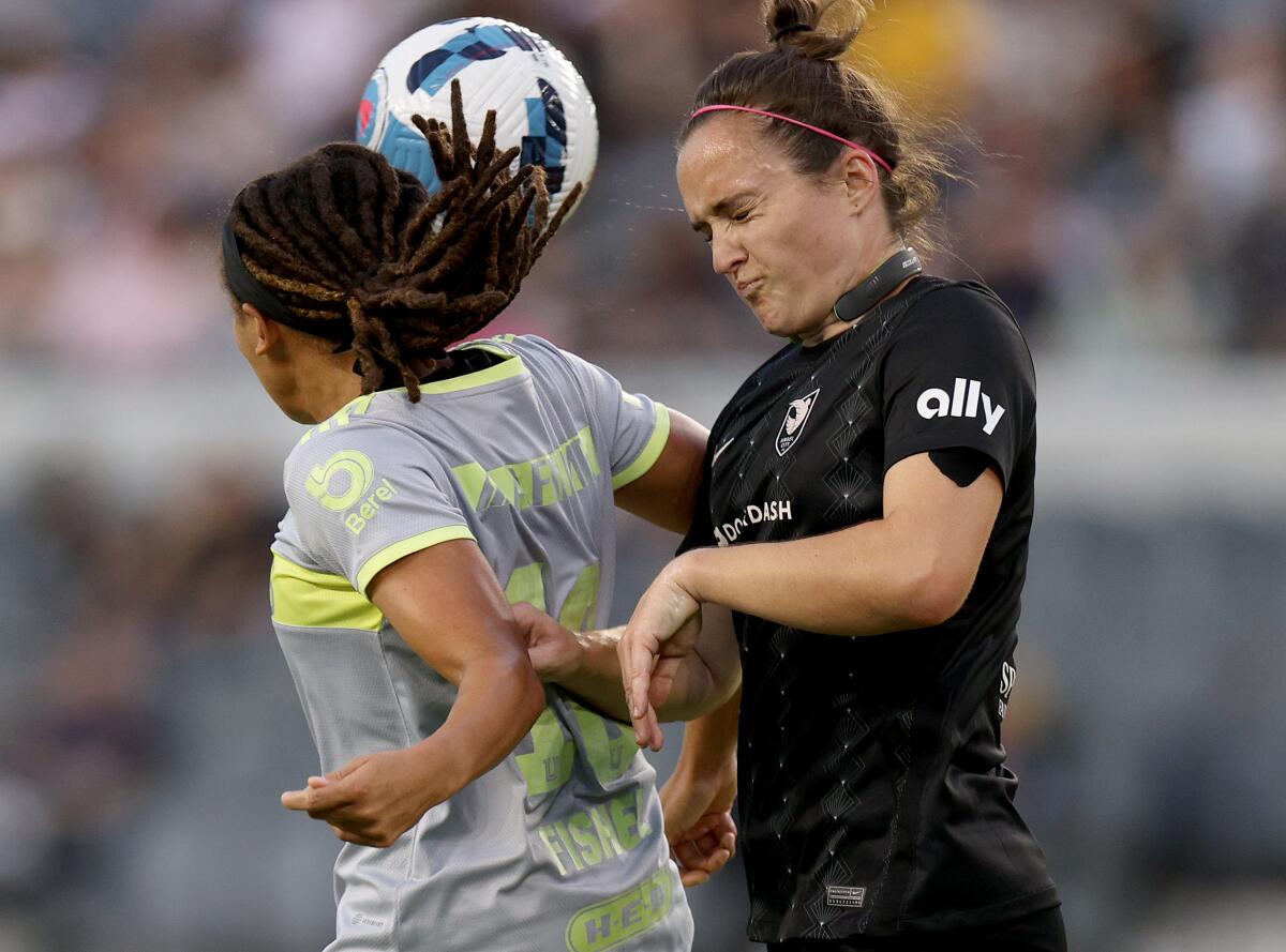 Angel City FC's Megan Reid and Tigres Femenil's Mia Fishel jump to head a cross.