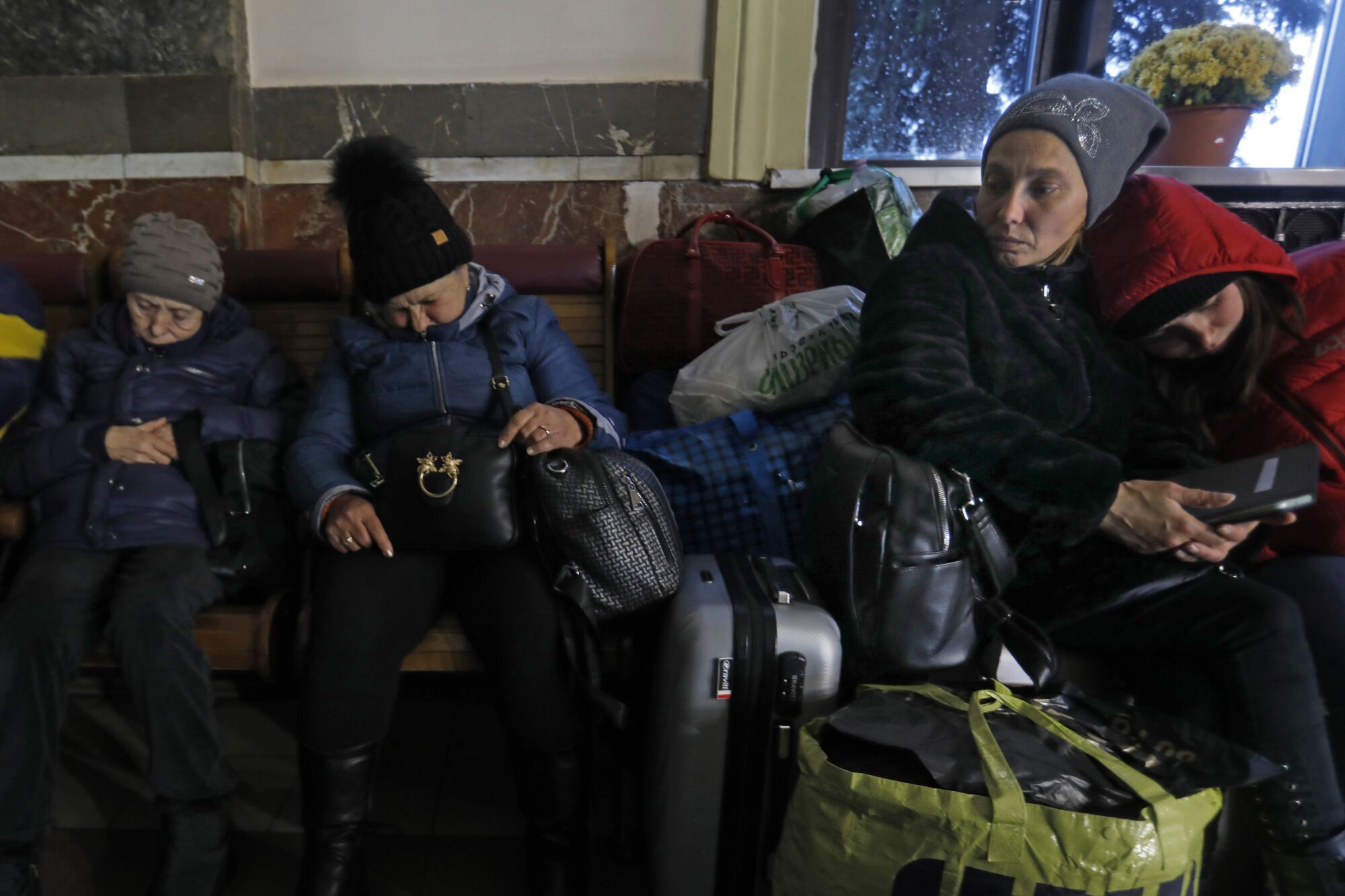 Family members wait for a train.