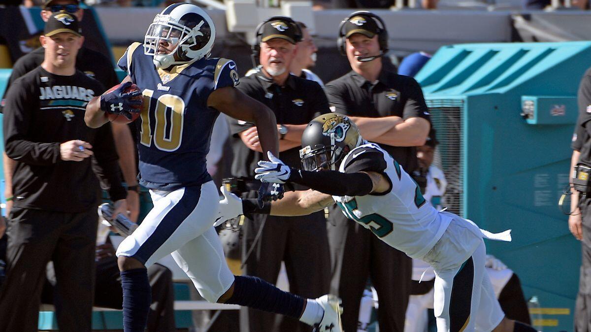 The Rams' Pharoh Cooper avoids a tackle by Jacksonville Jaguars safety Peyton Thompson as he returns a kickoff for a touchdown Sunday.