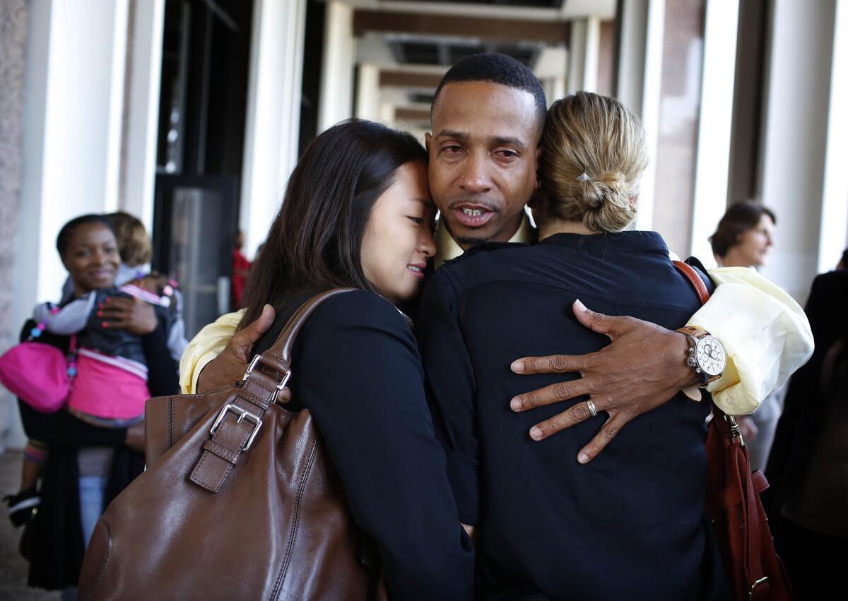 Obie Anthony hugs members of his legal team during a news conference. Last month, Los Angeles agreed to an $8-million settlement for Anthony, who was declared factually innocent by a judge after spending 17 years in prison.