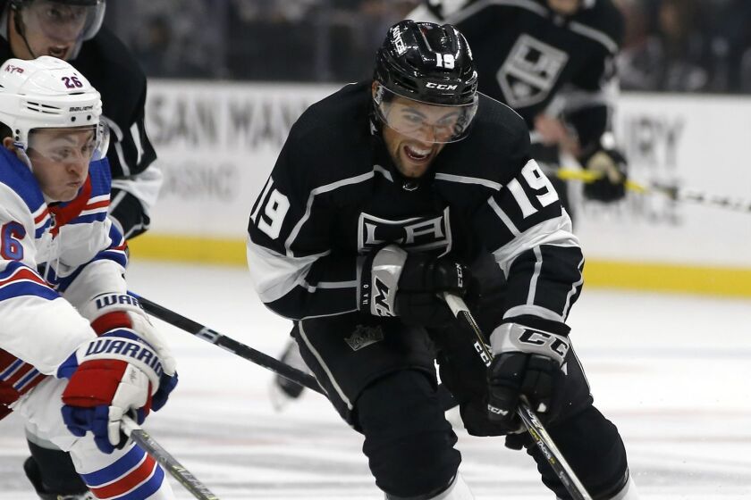 Los Angeles Kings left wing Alex Iafallo, right, controls the puck with New York Rangers left wing Jimmy Vesey (26) defending as Kings center Anze Kopitar (11), of Slovenia, pursues during the second period of an NHL hockey game in Los Angeles, Sunday, Oct. 28, 2018. (AP Photo/Alex Gallardo)