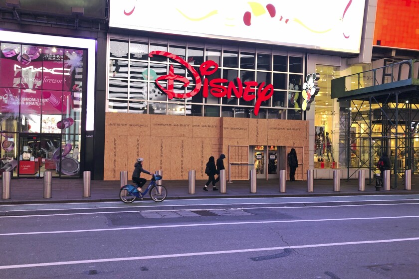 A Disney Store in New York's Times Square with boarded-up windows after the 2020 presidential election.