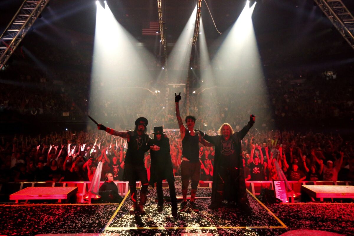 Motley Crue's Nikki Sixx, from left, Mick Mars, Tommy Lee and Vince Neil on their final tour at the Matthew Knight Arena in Eugene, Ore., in July.