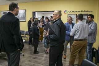 Guests gather in the offices of OC Human Relations during a tour of the Santa Ana nonprofit hub.