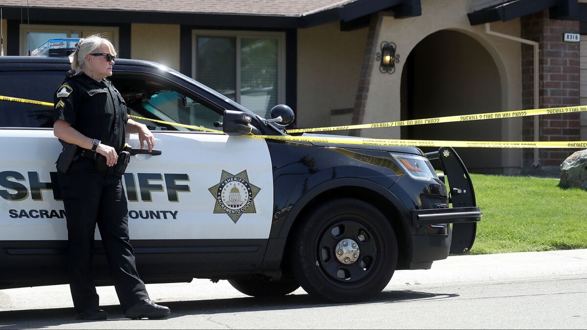A Sacramento County sheriff's deputy stands guard on April 24, 2018, in front of the Citrus Heights home of Joseph James DeAngelo, the suspected "Golden State Killer." The house was recently sold.