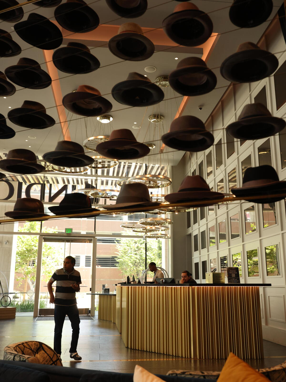 A visitant walks nether a show of hats successful a edifice lobby.