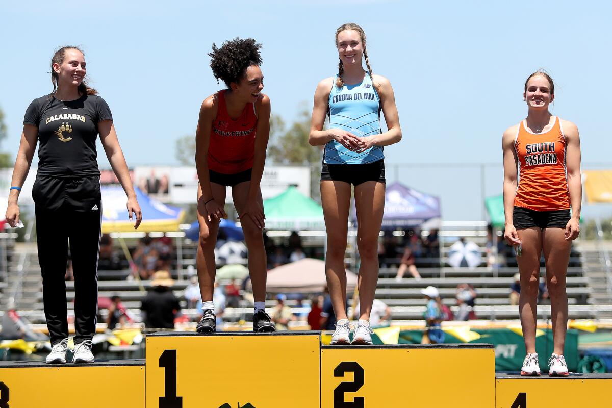 Corona del Mar's Caroline Glessing stands on the podium after placing second in the CIF Division 3 girls' long jump event.