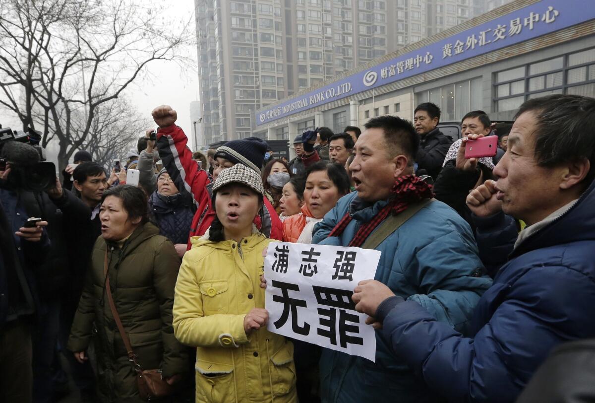 Supporters of prominent rights lawyer Pu Zhiqiang chant slogans as they gather during his trial in the Beijing Second Intermediate People's Court on Monday.