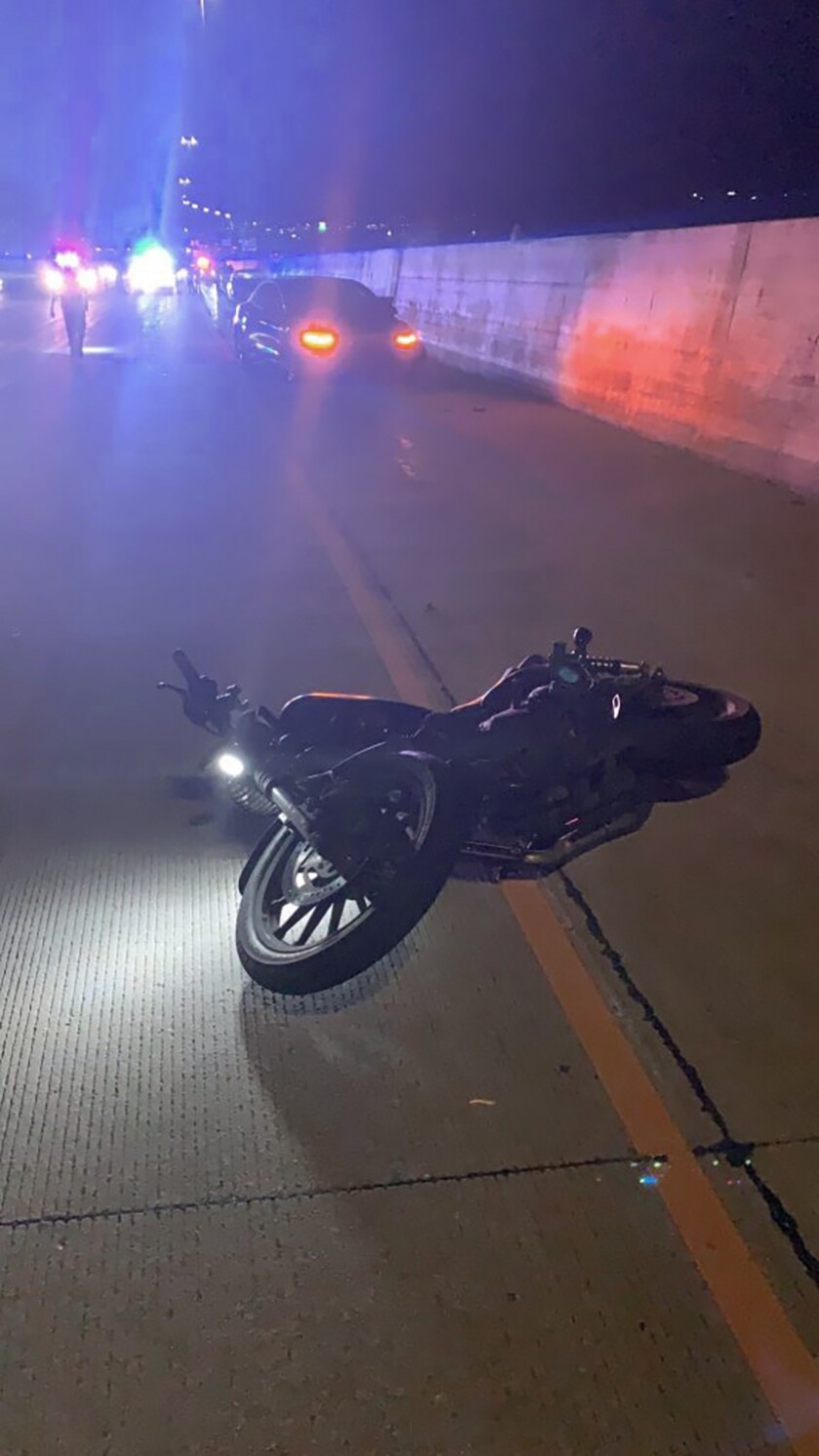 This photo provided by Utah Department of Public Safety shows the scene of an accident involving a Tesla and a motorcycle on July 24, 2022 near Draper, Utah. Two crashes involving Teslas apparently running on Autopilot are drawing scrutiny from federal regulators and point to a potential new hazard on U.S. freeways: The partially automated vehicles may not stop for motorcycles. (Utah Department of Public Safety via AP)