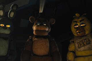 This image released by Universal Pictures shows, from left, Bonnie, Freddy Fazbear and Chica in a scene from "Five Nights at Freddy's." (Universal Pictures via AP)