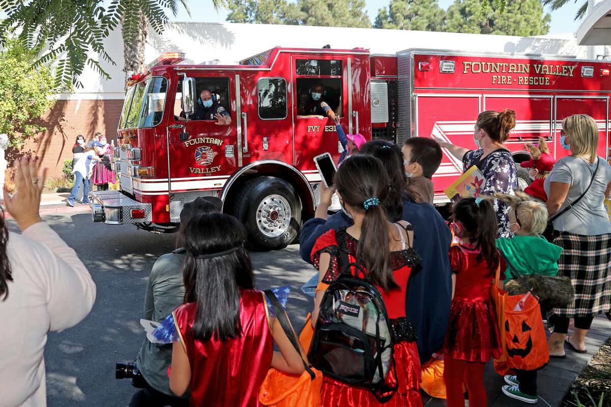 Fountain Valley fire and rescue members participate in a Halloween parade at Fountain Valley Regional Hospital on Oct. 30.