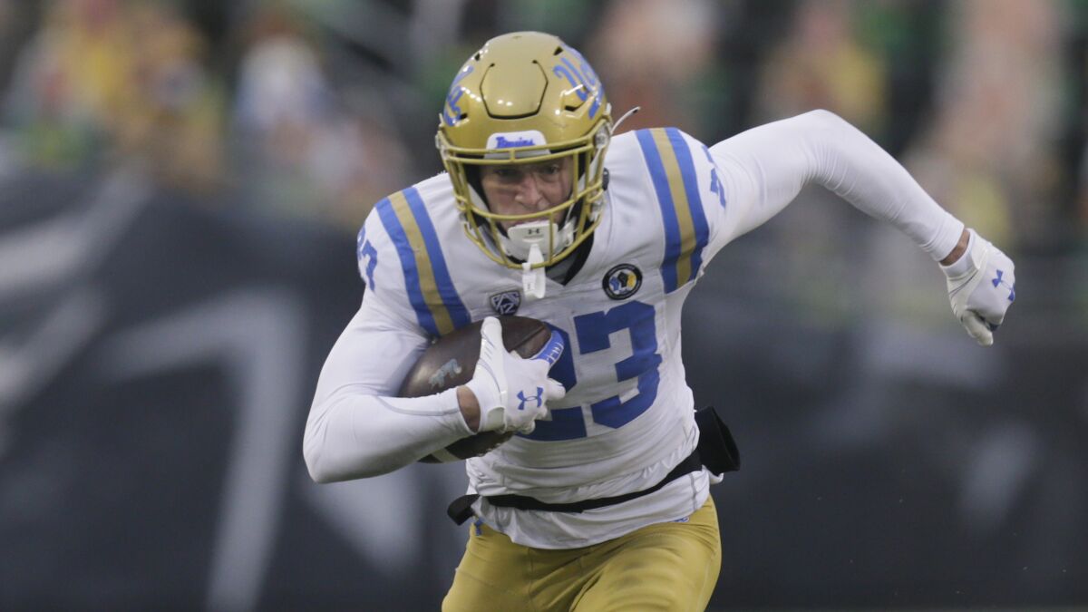 UCLA's Chase Cota runs with the ball after a reception against Oregon.