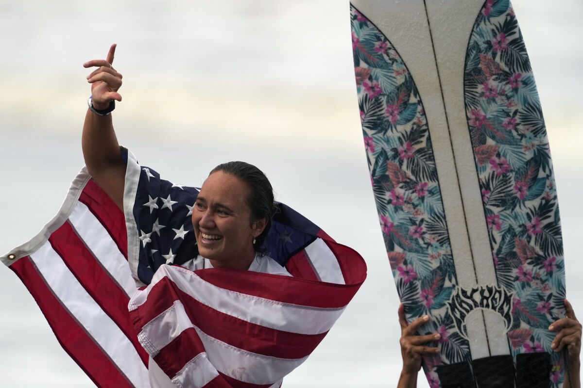 FILE - In this July 27, 2021, file photo, Carissa Moore, of the United States, celebrates winning the gold medal in the women's surfing competition at the 2020 Summer Olympics at Tsurigasaki beach in Ichinomiya, Japan. The first Olympic gold medalist for surfing, Moore, is the only Native Hawaiian surfer at the Games. (AP Photo/Francisco Seco, File)