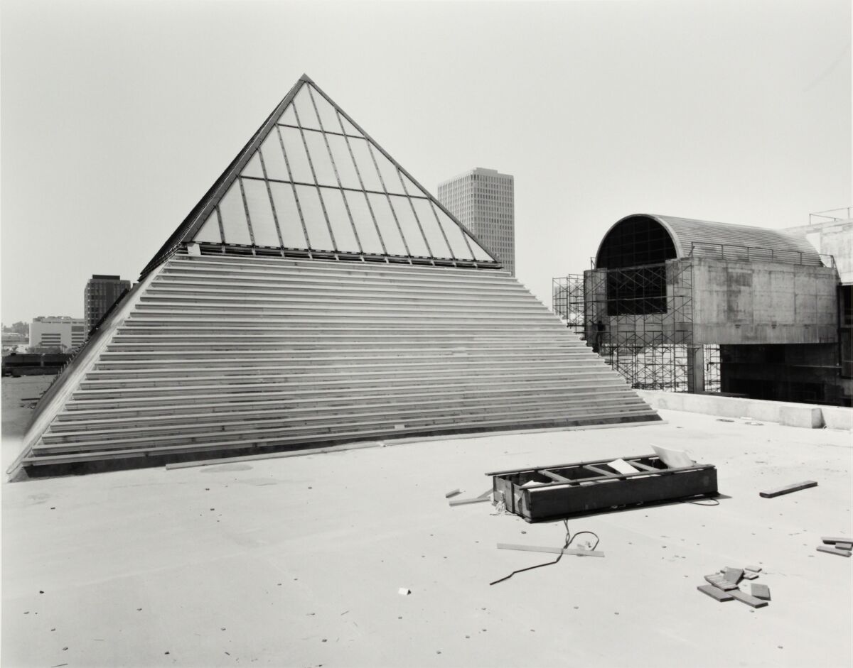 An older print shows a pyramid skylight in the foreground and a barrel vault surrounded by scaffolding in the rear.